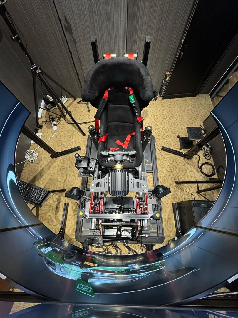 Overhead view of a fully harnessed bespoke motion simulator rig