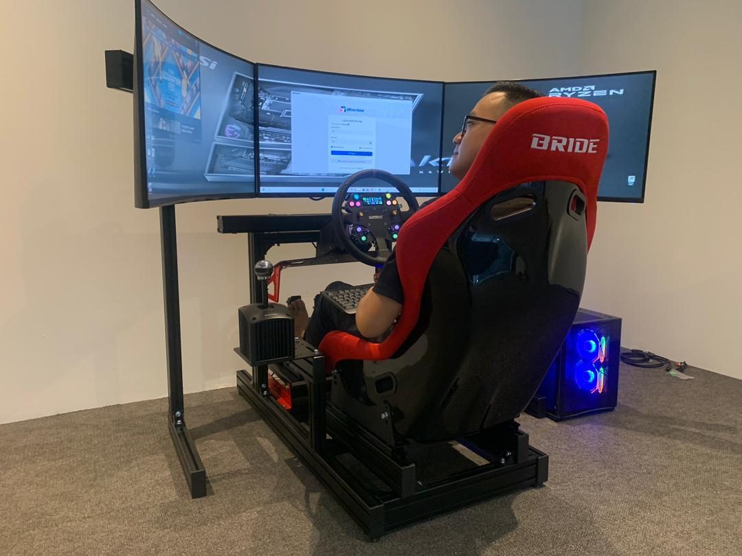Multi-screen production and simulator setup at a motorsport technology event