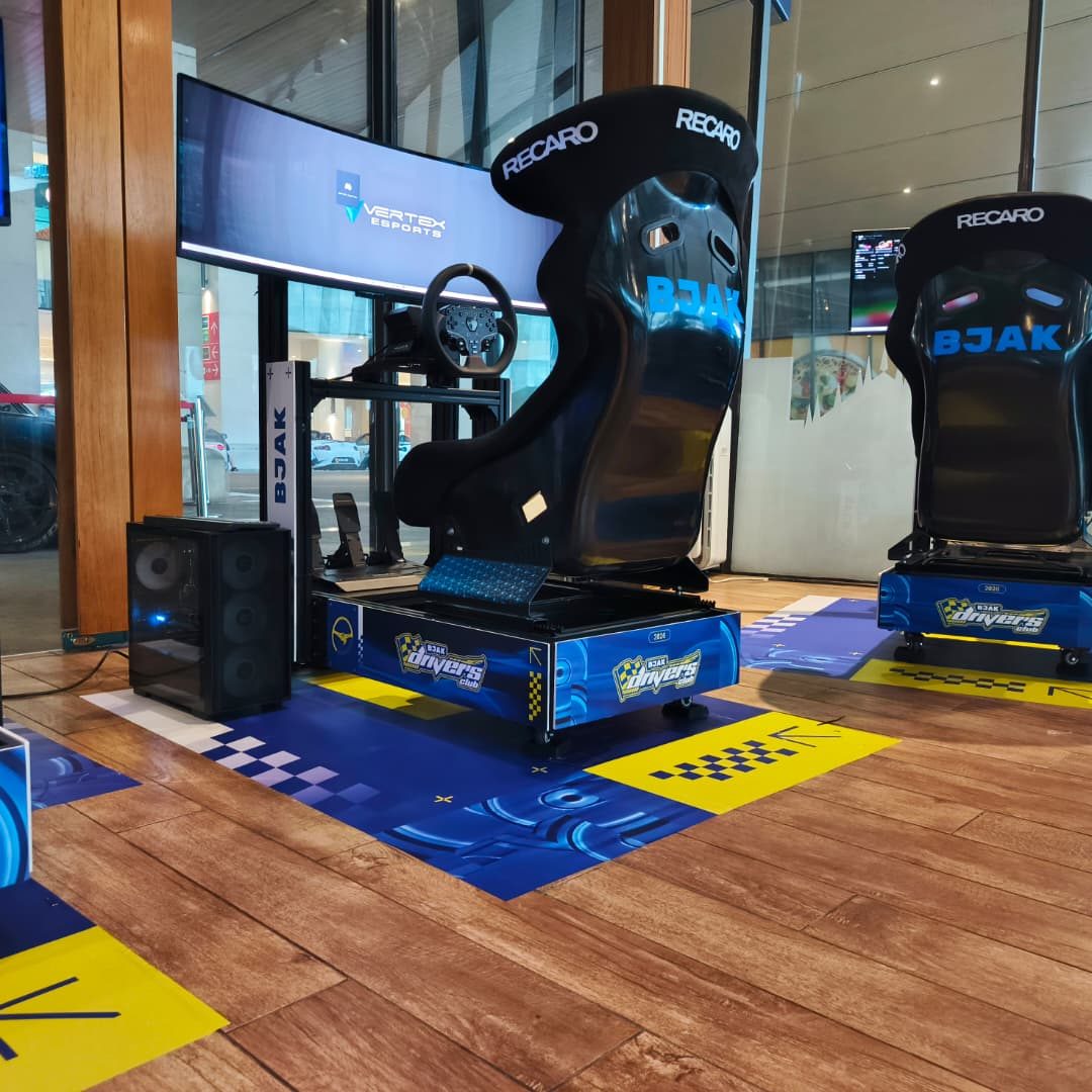 Branded sim racing rigs set up at a Vertex mall activation