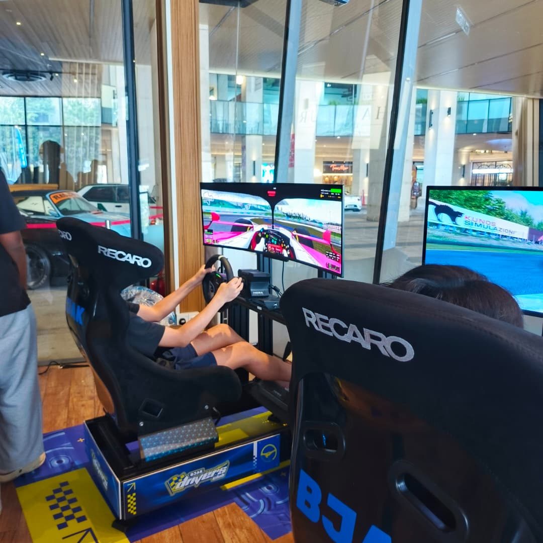 A player racing on a BJAK Drivers Club branded sim racing rig