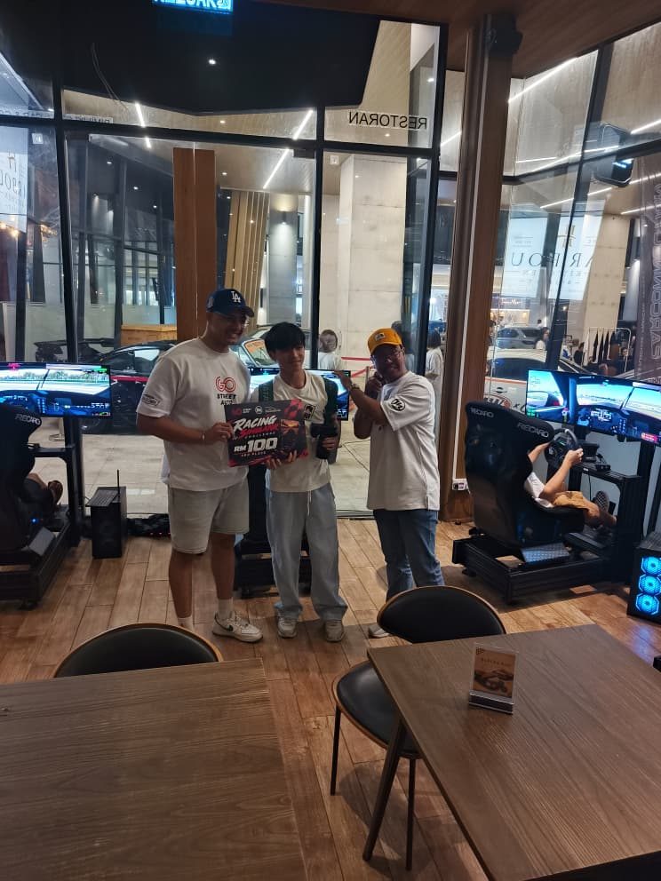 Prize-giving moment at a GoStreet x Vertex sim racing activation